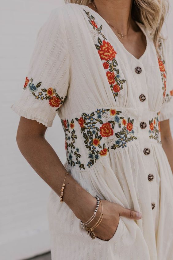 White dress embroidered with red and orange flowers